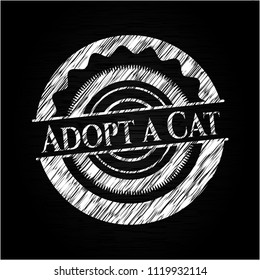 Adopt a Cat chalk emblem written on a blackboard