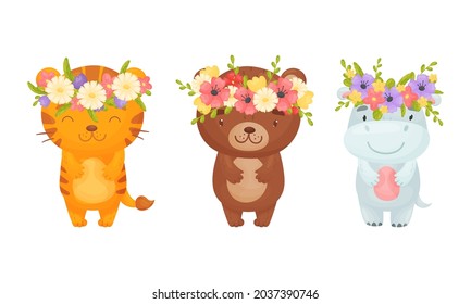 Adorable baby animals in wreaths of colorful flowers set. Lovely tiger, bear, hippo with floral wreath cartoon vector illustration