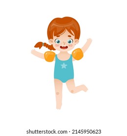 Adorable baby girl jumping with inflatable armbands. Funny red hair girl on summer vacations.