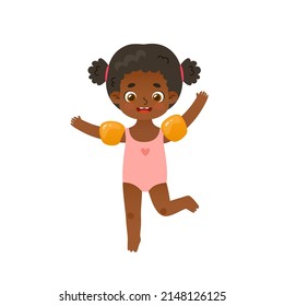 Adorable baby girl jumping with inflatable armbands. Funny african american girl on summer vacations.