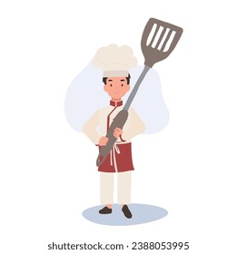 Adorable Child Chef Cooking with a Big Flipper. Kid Chef Holding Huge Flipper