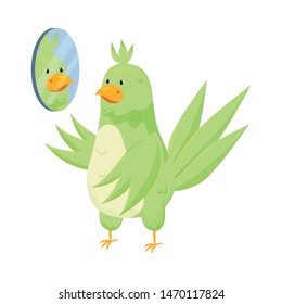 Adorable green tropical parrot is looking in room mirror