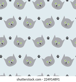 Adorable seamless pattern with light grey cat`s round head with big round green eyes, black nose and sharp ears and paw prints. May be used for wrapping paper, wallpaper, etc.