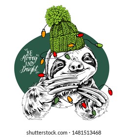 Adorable smiling sloth in a green knitted hat and with a light. Be merry and bright - lettering quote. Christmas and New year card, Humor composition, hand drawn style print. Vector illustration.