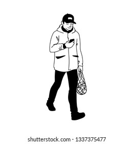 Adult man in warm jacket and baseball cap walking, looking at his smartphone. Monochrome vector illustration of man returns from supermarket with a package of fruit in simple line art style on white.