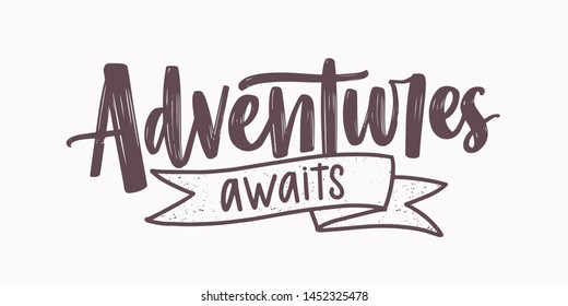 Adventure Awaits motivational message or phrase written with elegant cursive calligraphic font and decorated by ribbon. Modern lettering isolated on white background. Monochrome vector illustration.