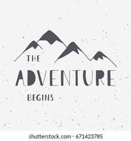 The adventure begins. Handwritten lettering phrase with mountains silhouette. Outdoor and travel concept. Vector illustrations for t-shirts, prints, posters, and cards design.