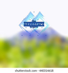 The Adventure Begins Logo on blurred mountain landscape background. Vector mountain exploration emblem. Outdoor activity symbol. Motivational quote