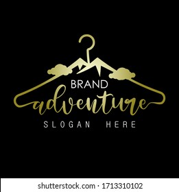 Adventure logo. initials "adventure" gold with mountains, coat hangers and black background