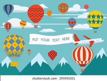 Advertising banners pulled by a plane with hot air balloons flying around.