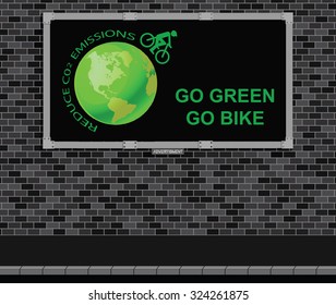 Advertising board on brick wall advertising Go Green Go Bike and reduce C02 emissions message 