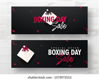 Advertising header or banner set with gift box on black background for Boxing Day Sale.