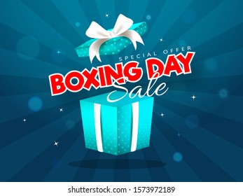 Advertising sale poster design with surprise gift box of Boxing Day on blue rays background.