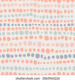 Aesthetic minimalist boho seamless pattern with hand drawn dots in mid century style in a natural color palette. Pastel naive nursery print design on a light background. Trendy kids backdrop.