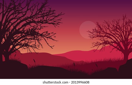 Aesthetic view of the silhouette of mountains and dry tree branches at dusk from the edge of the city. Vector illustration of a city