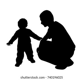 Affectionate father looking at his baby walking