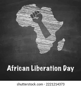 Africa with a fist hand drawn with chalk on a blackboard with the words "african liberation day“.

