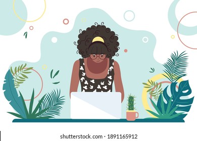 African American black woman working at a computer. Online education. Freelance worker, self-employed, student. Summer workplace interior design.