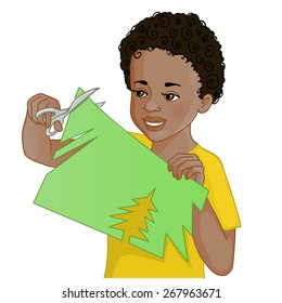 African American boy is cutting color paper with scissors