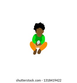 African American boy holding an egg in his hands.the boy is sitting on the ground