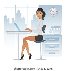 African american business woman working on a laptop computer at her office desk