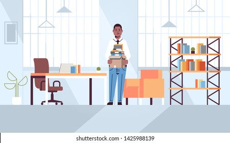 african american businessman office worker holding box with stuff things new job business concept creative workplace modern office interior flat full length horizontal