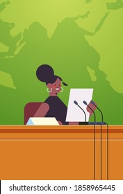 african american businesswoman giving speech at tribune with microphone on corporate international conference world map background vertical portrait vector illustration