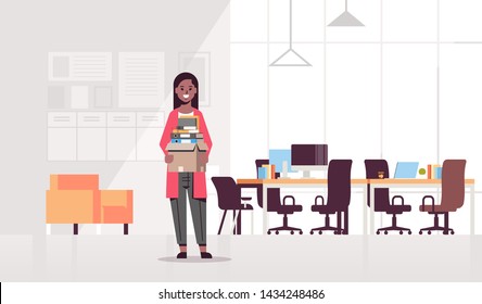 african american businesswoman holding box with stuff things new job business concept creative co-working center modern workplace office interior flat full length horizontal