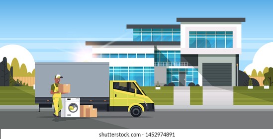 african american courier near delivery truck with cardboard boxes washing machine domestic appliances store goods purchase distribution concept cottage house exterior full length horizontal