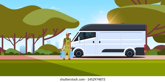 african american courier in uniform holding two bottles of fresh water express delivery service concept man near delivery truck landscape background flat full length horizontal