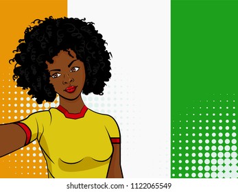 african american girl makes selfie in front of national flag Ivory Coast in pop art style illustration. Element of sport fan illustration for mobile and web apps on national flag background