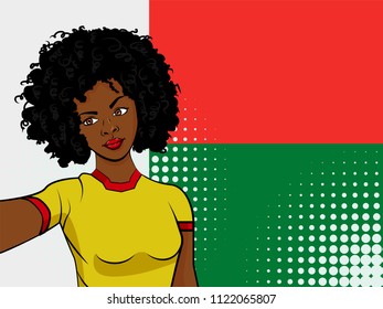 african american girl makes selfie in front of national flag Madagascar in pop art style illustration. Element of sport fan illustration for mobile and web apps on national flag background