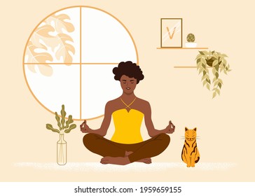 African American girl sits in the lotus position at home with her cat. The woman is engaged in yoga, meditation. Flat vector illustration