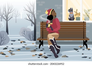 An African American girl sits on a bench in front of the house and looks at the cat in the window on a winter day. The girl is holding hot coffee in her hands. Flat vector illustration.