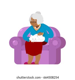 African American Grandmother and cat sitting on chair. granny cat lady. grandma and pet. old woman and animal. gammer and Beast
