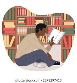 African American male student sitting in the library holding a book. Black History Month concept.