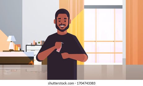 african american man applying antibacterial spray covid-19 virus bacteria disinfection stop coronavirus pandemic quarantine concept living room interior horizontal portrait vector illustration