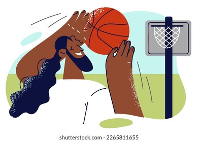 African American man with basketball in hands enjoy hobby of practicing to shoot at net. Positive guy plays with basketball alone to improve skills before competition and win over opposing team 