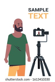 African American Man Blogger Recording Video Blog With Digital Camera On Tripod Live Streaming Social Media Blogging Concept Portrait Vertical Copy Space Vector Illustration