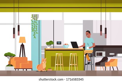 african american man freelancer using laptop working at home during coronavirus quarantine self-isolation social distancing concept modern kitchen interior horizontal full length vector illustration