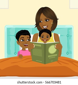 african american mother reading a book to son and daughter in bed before going to sleep