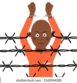 African american prisoner in broken handcuffs stands over barbed wire