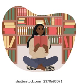 African American student sitting in the library holding a book in her hands. Black History Month concept.