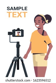 African American Woman Blogger Recording Video Blog With Digital Camera On Tripod Live Streaming Social Media Blogging Concept Portrait Vertical Copy Space Vector Illustration