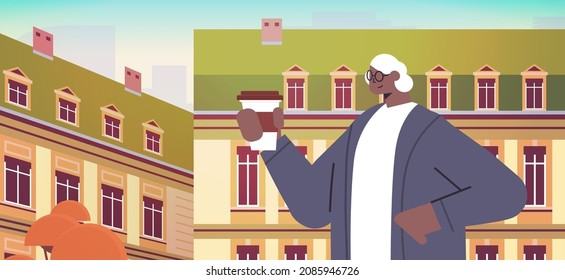 african american woman drinking coffee senior lady having coffee break cityscape background horizontal