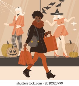 African American woman is shopping before Halloween. A girl with shopping bags walks near the windows of a clothing store. Flat vector illustration