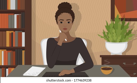 African American woman sits at desk and looks at the monitor. A young woman watches an online training webinar and takes notes. Remote work, study from home.