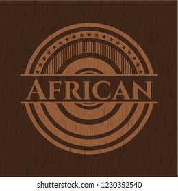 African badge with wooden background