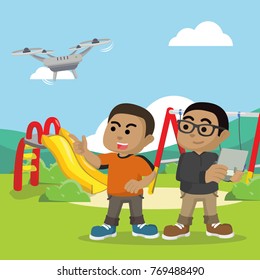 African boy playing drone with his friend at park