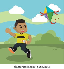 african boy playing kite in park